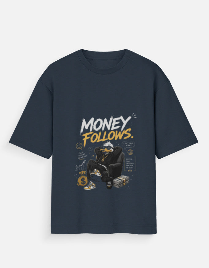 A navy blue short-sleeve t-shirt with a graphic print on the front. The graphic features the text 'MONEY FOLLOWS.