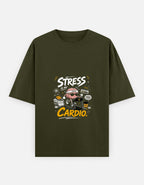 A olive green short-sleeve t-shirt with a distressed graphic on the front featuring the text 'STRESS IS MY CARDIO' and a pair of headphones, displayed against a light gray background.