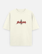 An off-white short-sleeve t-shirt with a stylized red and black 'SUKUNA' logo printed on the chest, displayed against a light gray background.