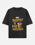 Black t-shirt with humorous graphic and text on a white background