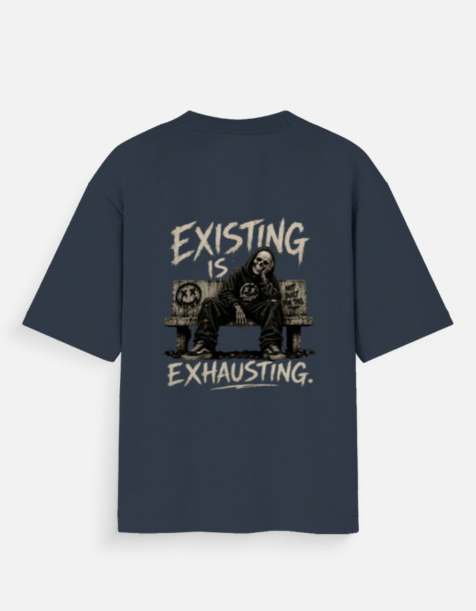 Blue oversized back print t-shirt featuring a tired man sitting on a couch with the quote "Existing Is Exhausting" in vintage grunge style by Kurowear.