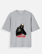 Gray t-shirt with a graphic of a skeleton and 'Stay Positive' text on a white background