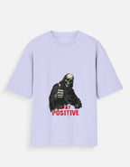 Light purple t-shirt with a graphic of a skeleton and 'Stay Positive' text on a white background