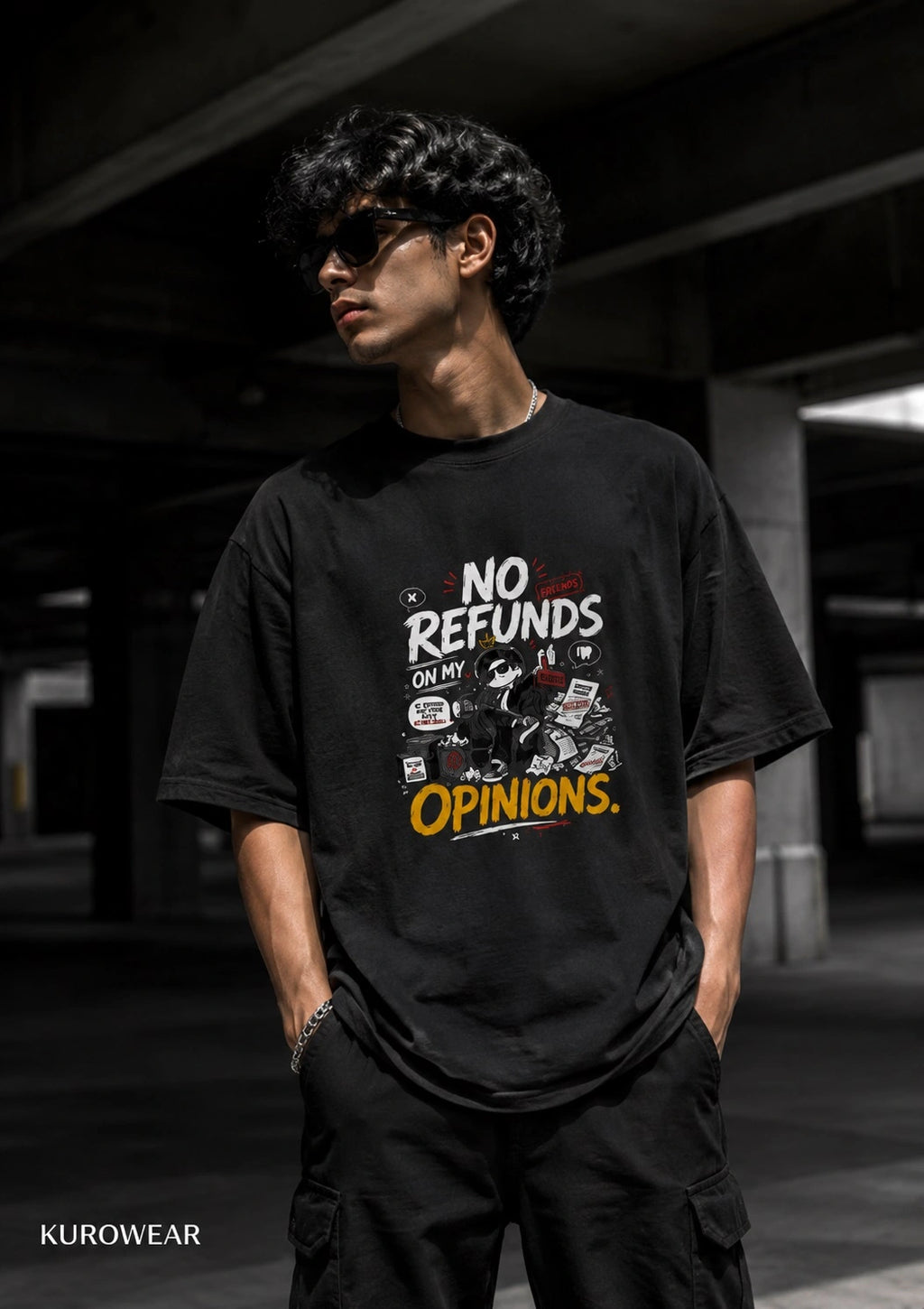 A man wearing a black graphic t-shirt with the text 'NO REFUNDS ON MY OPINIONS.' in white and yellow, standing in a dark concrete parking structure.