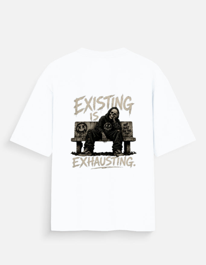 White oversized back print t-shirt featuring a tired man sitting on a couch with the quote "Existing Is Exhausting" in vintage grunge style by Kurowear.