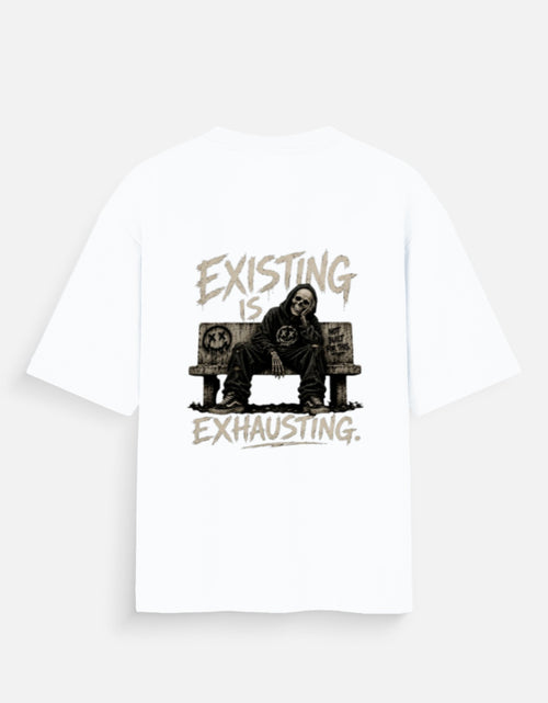 White oversized back print t-shirt featuring a tired man sitting on a couch with the quote "Existing Is Exhausting" in vintage grunge style by Kurowear.