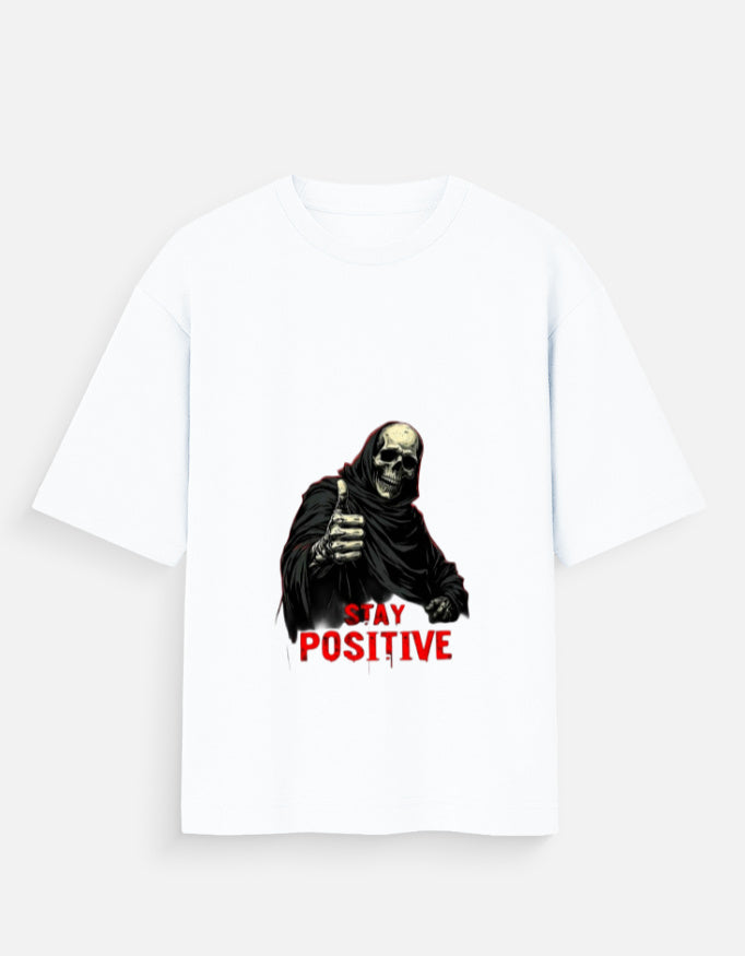 White t-shirt with a graphic of a skeleton holding a sign that says 'Stay Positive' on a white background.