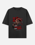 A black short-sleeve t-shirt with a graphic print of the anime character Apni on the front, featuring red and white text and Japanese characters, displayed against a light gray background.