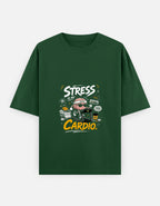 A dark green short-sleeve t-shirt with a graphic on the chest that reads 'STRESS IS MY CARDIO.' in white and yellow text, featuring a cartoon character in a heart-shaped helmet, shown against a light gray background.