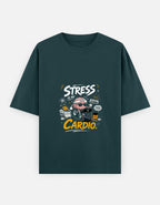 A green short-sleeve t-shirt with a graphic on the chest that reads 'STRESS IS MY CARDIO.' in white and yellow text, featuring a cartoon character in a heart-shaped helmet, shown against a light gray background.