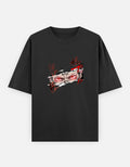 A black short-sleeve crewneck t-shirt featuring a stylized graphic print of a sukuna character's face with red eyes and red markings, displayed on a light gray background.