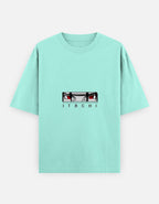 A mint green short-sleeve t-shirt featuring a graphic of the anime character Itachi Uchiha's eyes and the name 'ITACHI' printed below, displayed on a light gray background.