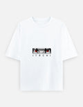 A white short-sleeve crewneck t-shirt featuring a graphic of the anime character Itachi Uchiha's eyes and the name 'ITACHI' printed below, displayed on a light gray background.